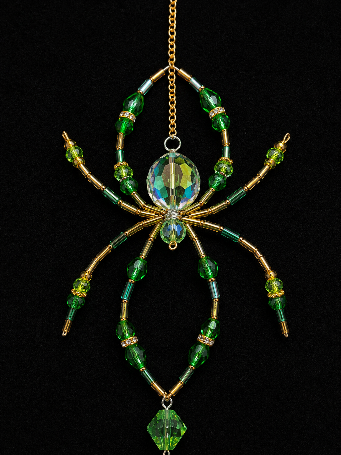 Green and gold beaded spider with shaped wire legs